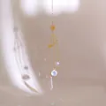 Macro shot of celestial sun and moon suncatcher with crystals casting rainbow reflections - 42.5cm / Multi-layer Celestial Style
