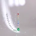 Close-up of spiral suncatcher with rainbow crystals and green faceted glass ball - Multicolor Beads With Green Ball (Swivel Ring Style)