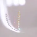 Detail of golden heart spiral stabilizer with crystal teardrop making rainbow light - Gold Spiral AB Color Pointed Teardrop Pendant