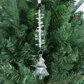 Close-up of clear acrylic Christmas tree pendant with faceted beads on a green tree - Christmas Tree Style One / Clear White