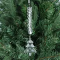 Close-up of clear acrylic Christmas tree pendant hanging on lush green pine branches - Christmas Tree Style Two / Clear White
