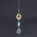 Detail of crystal sun catcher featuring a gold paw print pendant and large faceted prism ball - Style A Large Clear Crystal Ball / Gold