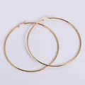 Macro view of large 18k gold plated stainless steel hoop earrings with polished finish - Jumbo Size / Gold
