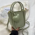 Secchiello verde menta con ciondolo a cuore e tracolla su blazer bianco - Verde