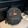 Dark grey denim backpack with leather accents and multiple pockets in retro style - Black