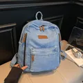 Light blue denim backpack with large capacity and brown leather zipper pull accents - Light Blue