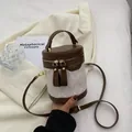 Bolso bombonera cilíndrico bicolor chic en marrón y blanco roto con textura acolchada - Blanco & Café