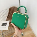 Emerald green hexagonal box bag with woven rope handle and gold chain strap for women - Green