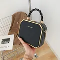 Octagonal black acrylic box bag with gold trim and Fashion & Bag lettering on the front - Black