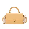 Fashionable beige crossbody bag with woven handle and elegant silk scarf details - Yellow