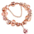 Detail of rose gold charm bracelet with champagne crystal beads and heart pendant - Size 17 / Rose Gold & Pink