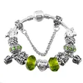 Close-up of silver snake chain bracelet with green charms and I Love You heart pendant - Green / 17cm