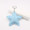 Macro view of light blue star-shaped leather keychain with embossed texture and silver ring - Sky Blue