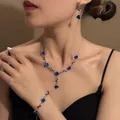 Elegant French vintage jewelry set featuring blue roses on a silver chain close-up - Necklace Bracelet And Earrings Set (E2172-2) / Silver/Blue