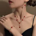 Close-up of vintage red rose jewelry set including necklace, bracelet and earrings - Necklace Bracelet And Earrings Set (E2167-5) / Gold/Red