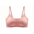 Detailed view of pink seamless bra featuring wavy scalloped edges and adjustable straps - Pink