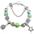 Detail view of silver charm bracelet featuring green enamel flowers and a star pendant - 16cm / Green