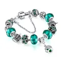 Silver crown bracelet featuring emerald green faceted beads and floral charms on white background - 17cm / Peacock Blue