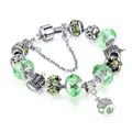 Silver snake chain bracelet with green crystal beads and a crown pendant on white background - 17cm / Light Green