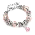 Detailed view of a pink beaded charm bracelet with crystal drops and heart pendant - 20+5cm / Pink