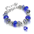Fashion alloy charm bracelet with deep blue glass beads and heart pendant on white background - Sapphire Blue