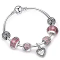 Silver snake chain bracelet with pink glass beads and heart charms on white background - 17cm / Pink