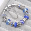 Blue glass bead charm bracelet with silver snake chain and floral patterns - Blue / 16cm