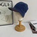 Blue and grey striped knitted peak hat for women shown on a minimalist white display stand - M (56-58cm) / Blue