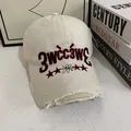 Close-up of vintage cream baseball cap with red embroidery and distressed brim details - M (56-58cm) / Off White