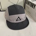 Detail view of quick-dry five-panel camper hat with metal eyelets and Nature Trek logo - M / Gray