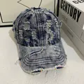 Close-up of distressed denim baseball cap with frayed holes and colorful stitch detail - M (56-58cm) / Blue Denim With Rainbow Stitching
