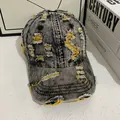 Detailed view of distressed black denim baseball cap with yellow contrast stitching accents - M (56-58cm) / Black Gray Denim With Yellow Stitching