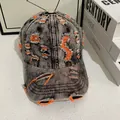 Close-up of vintage distressed denim baseball cap with orange inner lining detail - M (56-58cm) / Black Gray Denim With Orange Stitching