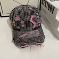 Close-up of distressed vintage denim baseball cap with pink frayed ripped detailing - M (56-58cm) / Black Gray Denim With Pink Stitching