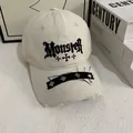 Macro detail of gothic Monster embroidery and metal studs on distressed baseball cap brim - M (56-58cm) / White