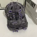 Close-up of distressed denim baseball cap with torn details and purple inner fibers - M (56-58cm) / Black Gray Denim With Purple Stitching