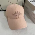 Detail of light pink baseball cap featuring intricate computer embroidery and curved brim - M (56-58cm) / Pink