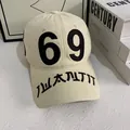 Close-up of beige baseball cap featuring black 69 embroidery and streetwear details - M (56-58cm) / Off White