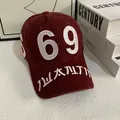 Detailed close-up of white embroidered 69 on a dark red vintage cotton baseball cap - M (56-58cm) / Burgundy