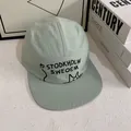 Detail of light green 5-panel camp hat with black cat embroidery and stitched flat brim - M(56-58cm) / Green
