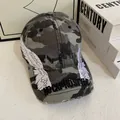 Detailed embroidery of white angel wings on a distressed camouflage baseball cap - M (56-58cm) / Camouflage