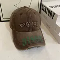 Detailed macro view of distressed vintage baseball cap with embroidery and frayed edges - M (56-58cm) / Coffee