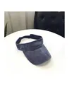 Detail view of the gray-blue washed denim visor with adjustable strap on a white table - M / Navy Blue