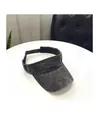 Detail of washed cotton sun visor with wide brim and adjustable buckle strap on white table - M / Black