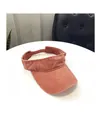 Close-up of coral pink washed cotton sun visor with wide reinforced stitched brim - M / Orange