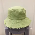 Detail showing frayed edge craftsmanship and canvas texture of light green bucket hat - M (56-58cm) / Green