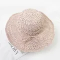 Close-up of hand-woven straw hat with delicate bow detail and wide wavy brim - M (56-58cm) / Pink