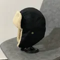 Close-up of black aviator hat featuring warm beige faux shearling lining and metal buckle - M (56-58cm) / Black