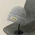 Detail of grey chunky knit beanie with decorative cross-stitch patch and soft mohair texture - M (56-58cm) / XXX Embroidery Patch Style / Gray