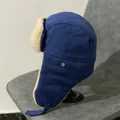 Detail view of winter pilot hat with navy canvas exterior and soft cream faux fur lining - M (56-58cm) / Blue